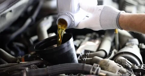 Locksmith pours car engine oil slow motion 4k movie Video stock 261693584