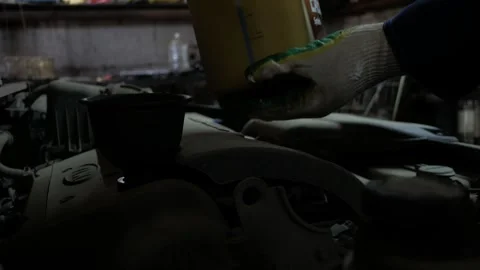 Locksmith pours car engine oil. Car service. Vertical format Stock Footage 276881506