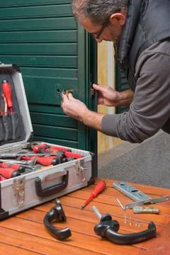 Locksmith repair the lock Stock Photos