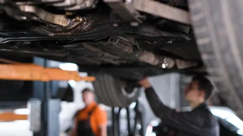 The locksmith repairs the car. Replacement of brake discs and pads. Car repair Video stock 199482323