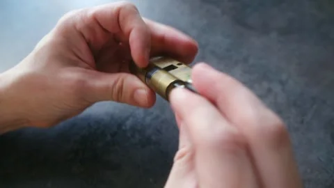Locksmith showing how a key interacts with a lock cylinder mechanism Stock Footage 337892465