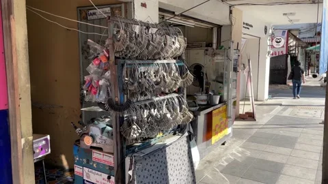 Locksmith street key maker vendor on sidewalk sunny day, Bangkok Stock Footage 230960861