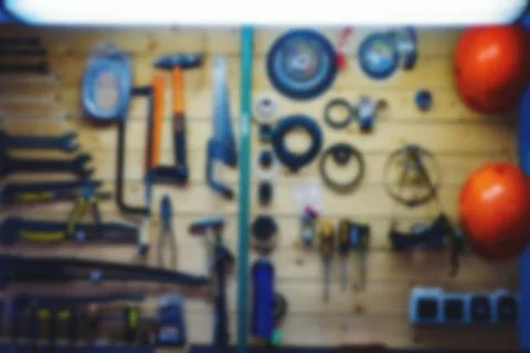 Locksmith tools hanging on wall. Back with blur effect. Background for insertion Stock Photos