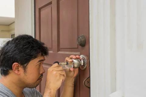 Locksmith try to open the door with ghost key maker Stock Photos