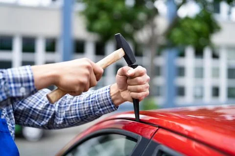 Locksmith Using Wedge Tool To Open Locked Door Stock Photos