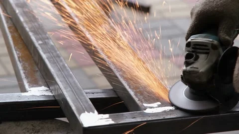 Locksmith working with angle electric grinder tool, sparks flying Stock Footage 234991497