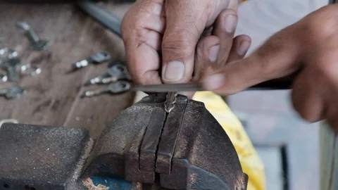 Locksmith working on a key. Handmade work. Close up Stock Footage 101599013