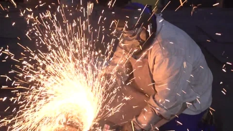 Locksmith works on metal processing with angle grinder with sparks. Stock Footage 274431288