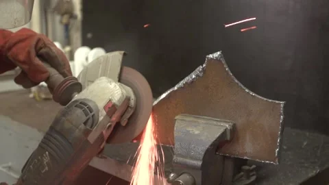 Locksmith works on metal processing with angle grinder with sparks Stock Footage 274431289