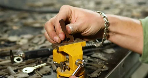 Locksmith in workshop attaches new key Stock Footage 202641406