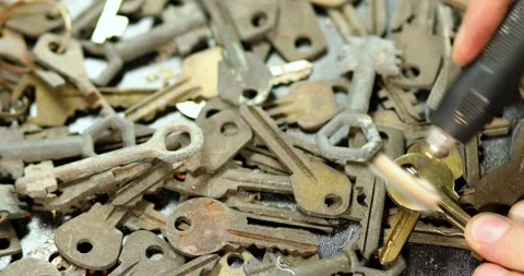 Locksmith in workshop makes new key, use grinding engraving machine Stock Footage 194107164