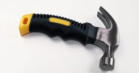 A locksmiths hammer with a round striker and a rubberized handle is used for Stock Footage 315338884