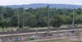Locomotive Pulling Colorful Containers Cargo Wagons Rail Freight Train Passing 4k or 4k+ Resolution