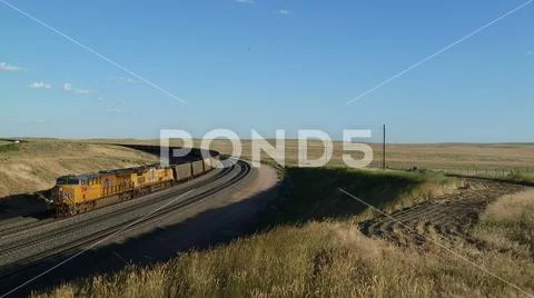 Locomotives and coal train rounding a track curve in the Powder River Basin Stock Photos