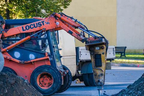Locust 903 shear loader breaks asphalt road works Stock Photos