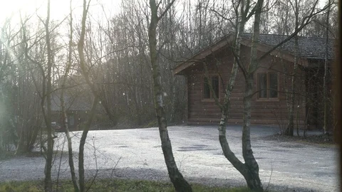 Lodges with a light dusting of snow as snowflakes are carried on a light breeze Video stock 86474424