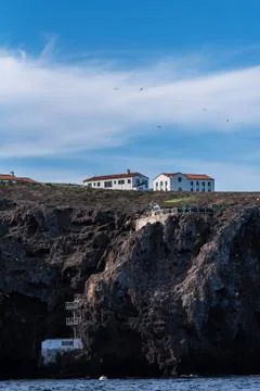 Lodging situated between blue sky and blue ocean. Stock Photos