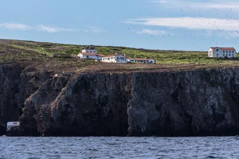 Lodging situated between blue sky and blue ocean. Stock Photos