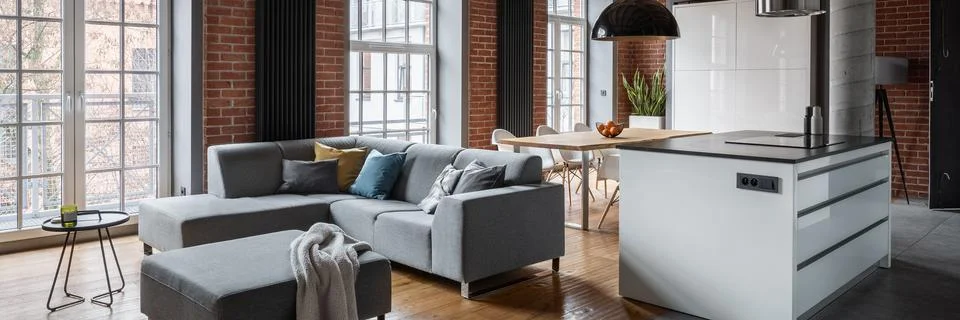 Loft interior with corner sofa Stock Photos