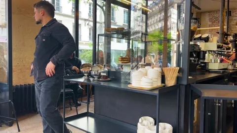 Loft style interior elements, long counter with several baristas. Video stock 311946560
