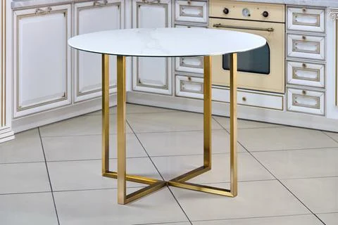 Loft-style kitchen table with round light stoneware countertop and golden Stock Photos