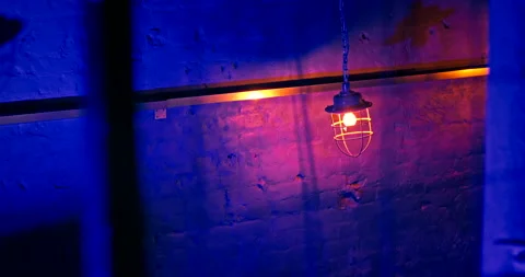 Loft-style lanterns suspended from long chains in nightclub against a brick wall Stock Footage 220881828