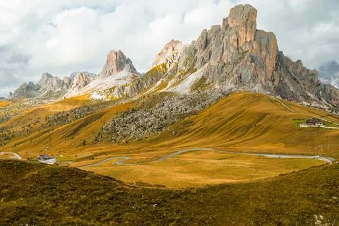 A lofty mountain range covered by clouds on the slopes of the famous Giau Pass Stock Photos