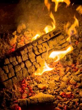A log burning in a fire pit at night Stock Photos