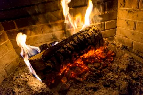 Log is burning in fireplace Stock Photos
