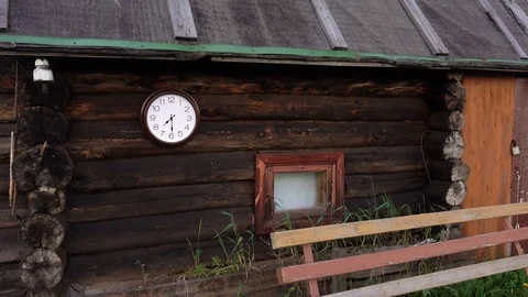 Log cabin. Clock in the foreground. Time concept. Stock Footage 92785409