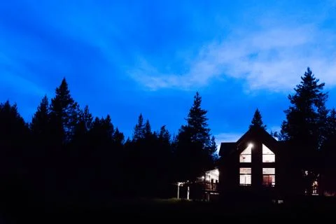 Log cabin at twilight Stock Photos