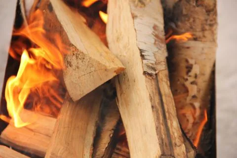 Log in the flames. burning fire in the grill is large. Stock Photos
