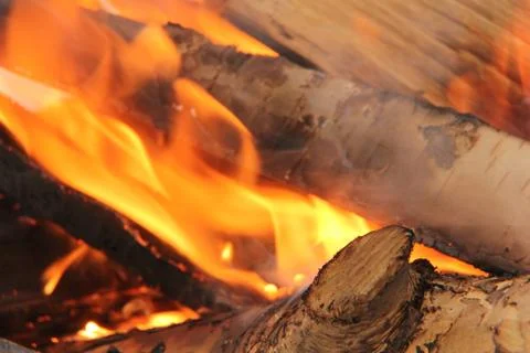 Log in the flames. burning fire in the grill is large. Stock Photos