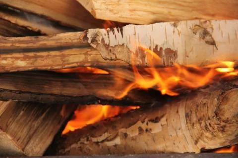 Log in the flames. burning fire in the grill is large. Stock Photos