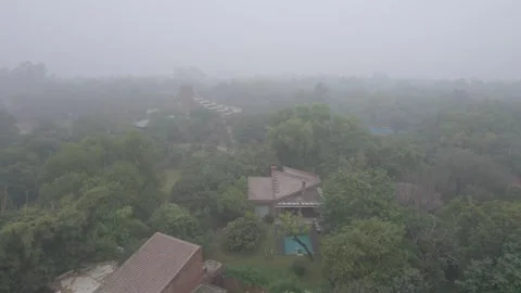 Log flat profile Aerial drone shot flying over trees red brick buildings during Stock Footage 331263310