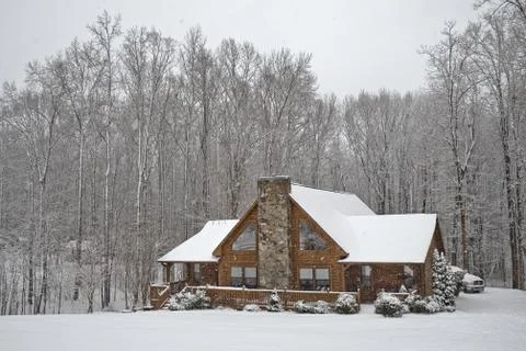 Log house in snowfall Stock Photos