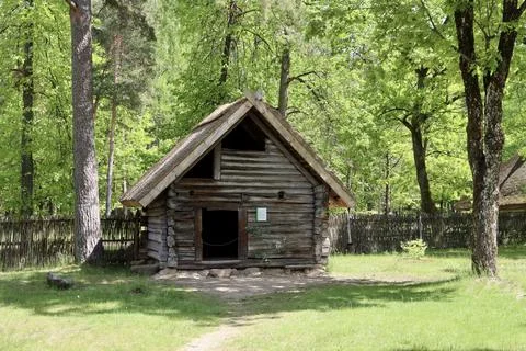 Log house with thatched roof Stock Photos