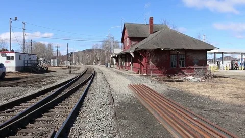 Log truck passes the defunct train station in Jackman, Maine Stock Footage 81413490