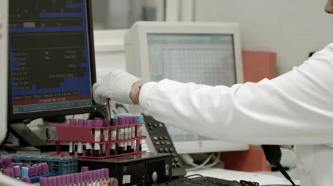 Logging blood into auto analyser device Stock Footage 49060140