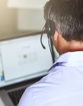 Logging the query. Over the shoulder shot of a man working on his laptop. Stock Photos
