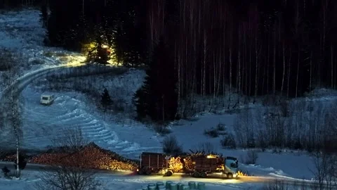 Logging truck loaded with log timber at night during winter, working in forest Stock Footage 331302524