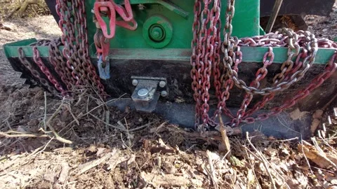 Logging winch mounted on a tractor with heavy iron chains in the forest Stock Footage 333642934
