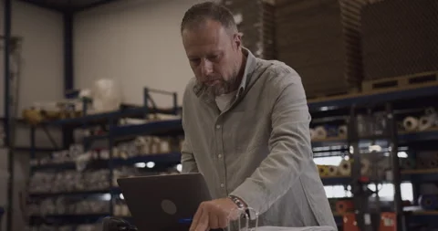 Logistic Shipping Manager Looking at Inventory in Folder Stock Footage 254609043