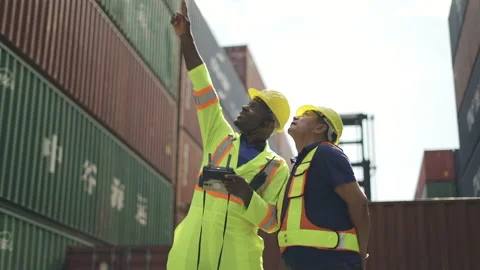 Logistic staff flying drone to survey container in shipment company area. Stock Footage
