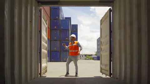 Logistic worker engineer man working in cargo container warehouse industry fa Stock Footage 147651217