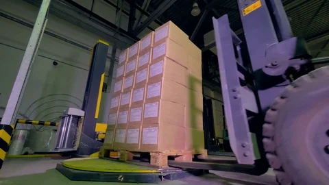 Logistics and shipping facility. Forklift move boxes and goods in warehouse. 4K. Stock Footage