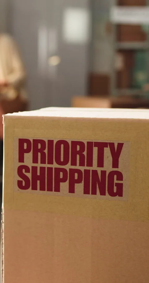 Logistics, box and priority shipping label in office, package distribution and Stock Footage 333323853