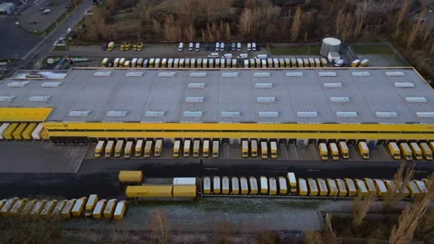 Logistics center building, delivery vans providing distribution. Great aerial Stock Footage 322186959