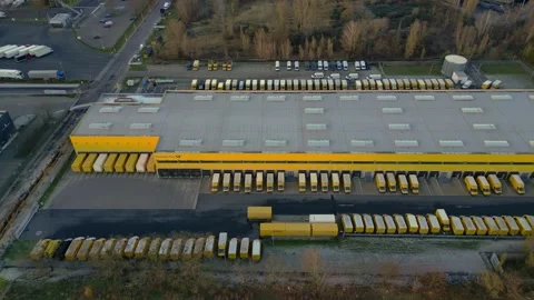 Logistics center building, delivery vans providing distribution. Perfect aerial Stock Footage 322186969