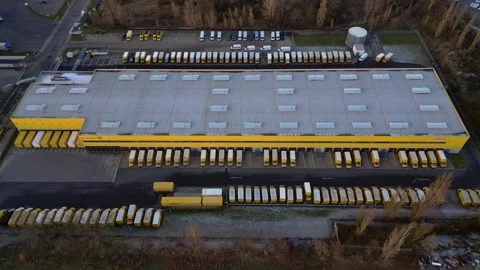 Logistics center building, delivery vans providing distribution. Unique aerial Stock Footage 322186987